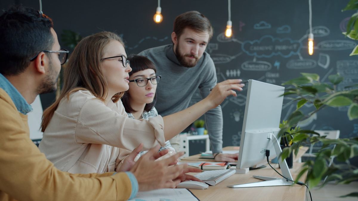 Team reviewing campaign creative together around a desk