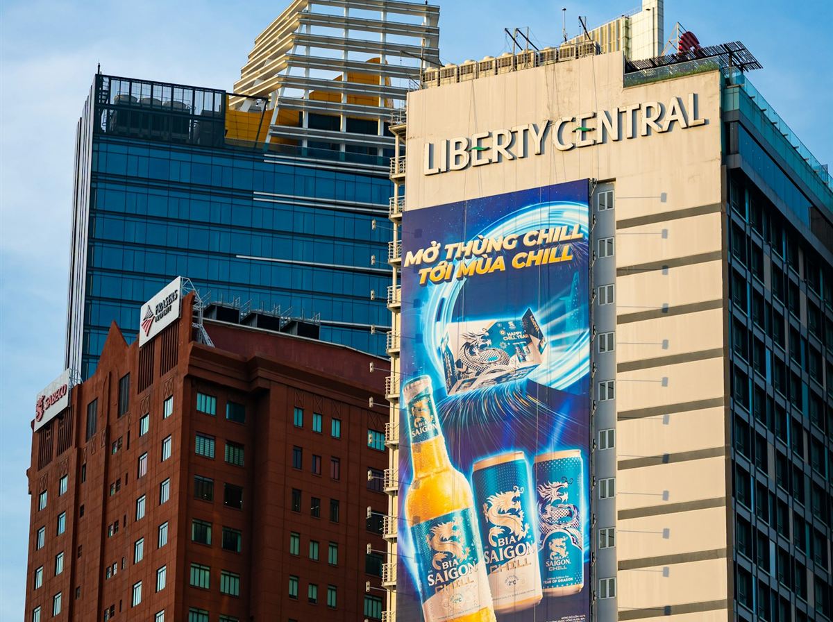 Large building-mounted advertisement covering the side of a high-rise tower
